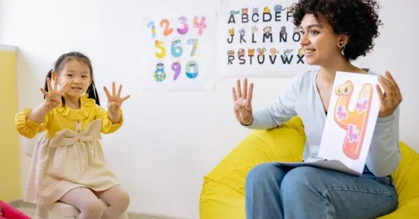 Teacher engaging with a child in a classroom
